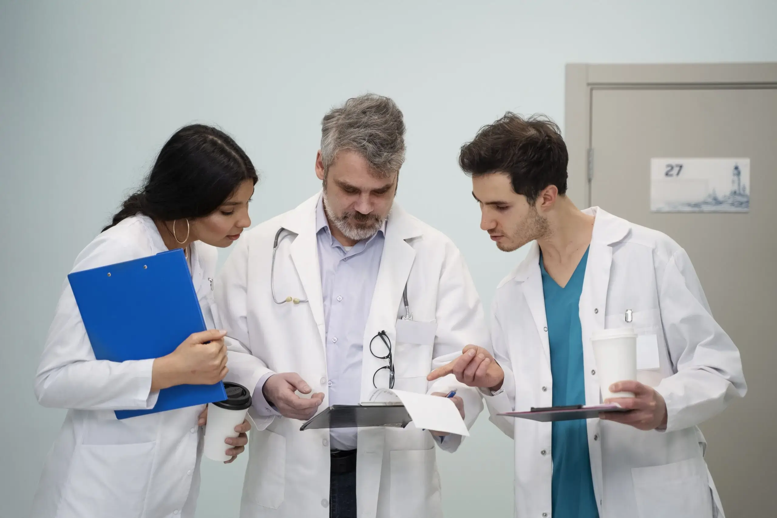 a doctor holding patient annual medical report and his collogues giving opinion on that