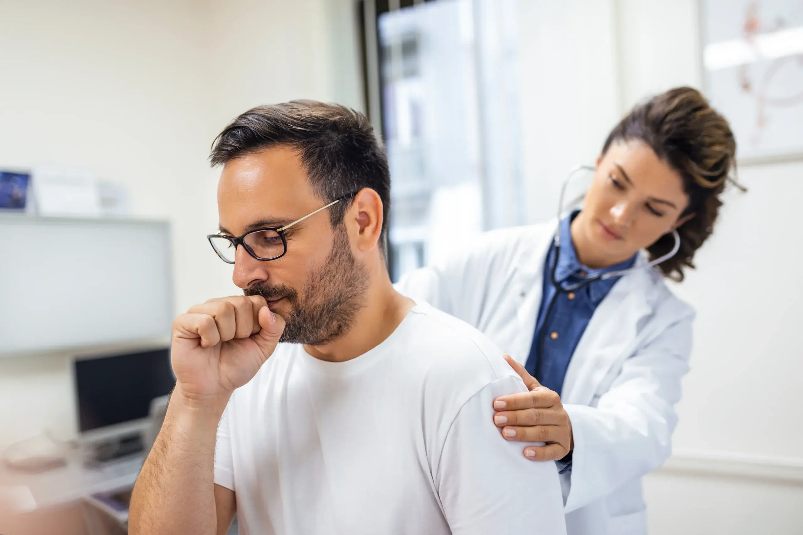 female doctor performs auscultation lungs on patient with coped symptoms